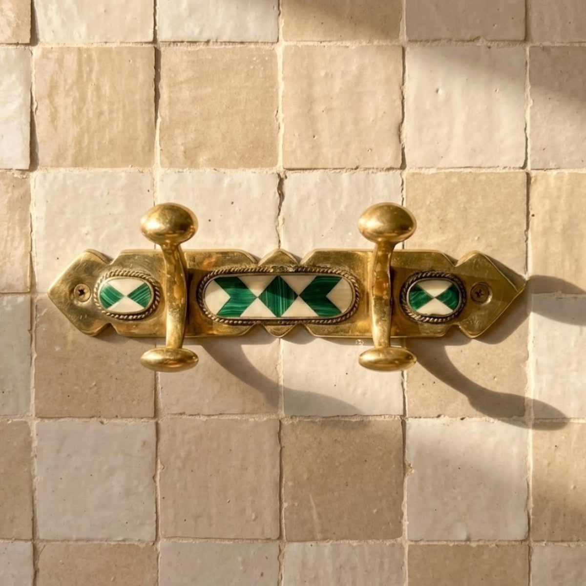 The Riad hook rack, hammered brass finish